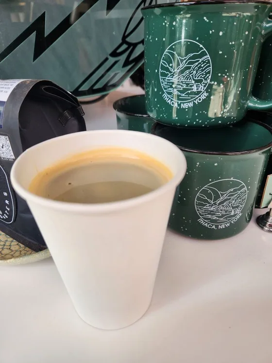 Coffee cup with green Press Cafe merchandise mugs
