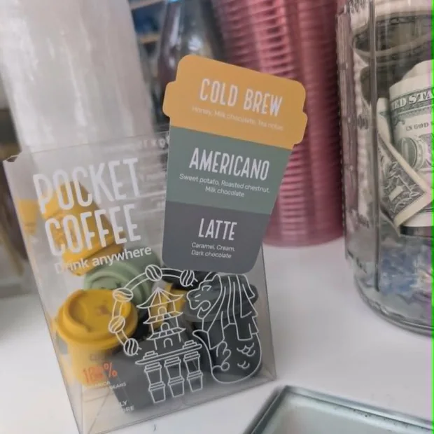 Press Cafe counter detail with packaged coffee products and a flavor card